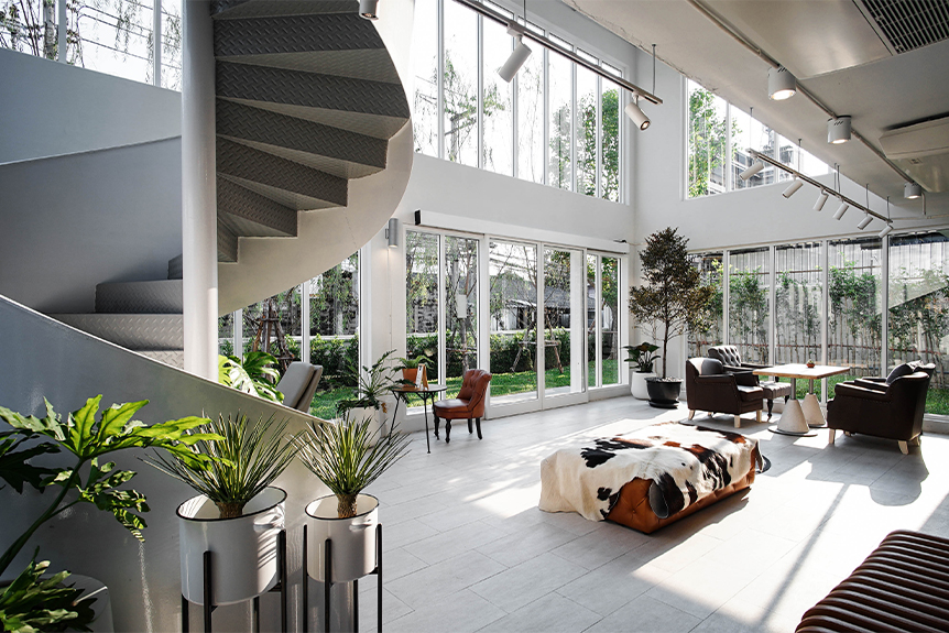 Something Bespoke Bangkok showroom — natural light, custom upholstery, spiral staircase