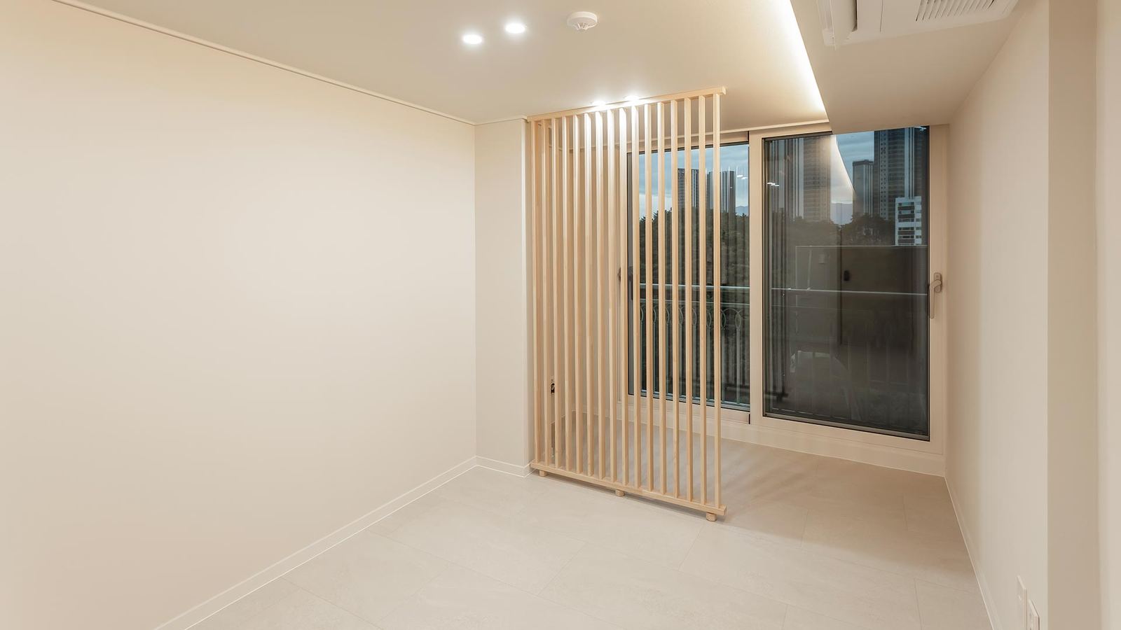 Style reference: a wood slat partition dividing a bedroom from a balcony window