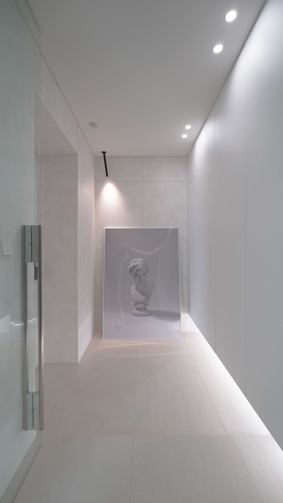 Style reference: a gallery-style hallway with a framed art piece and accent lighting