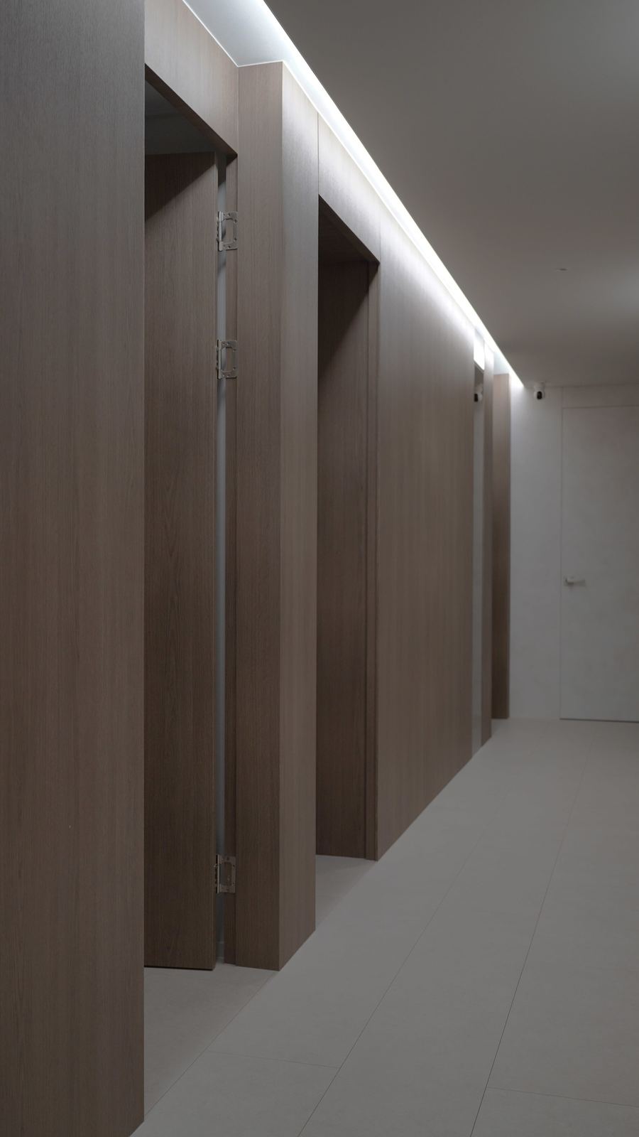 Style reference: a wood-panelled corridor with recessed door lighting