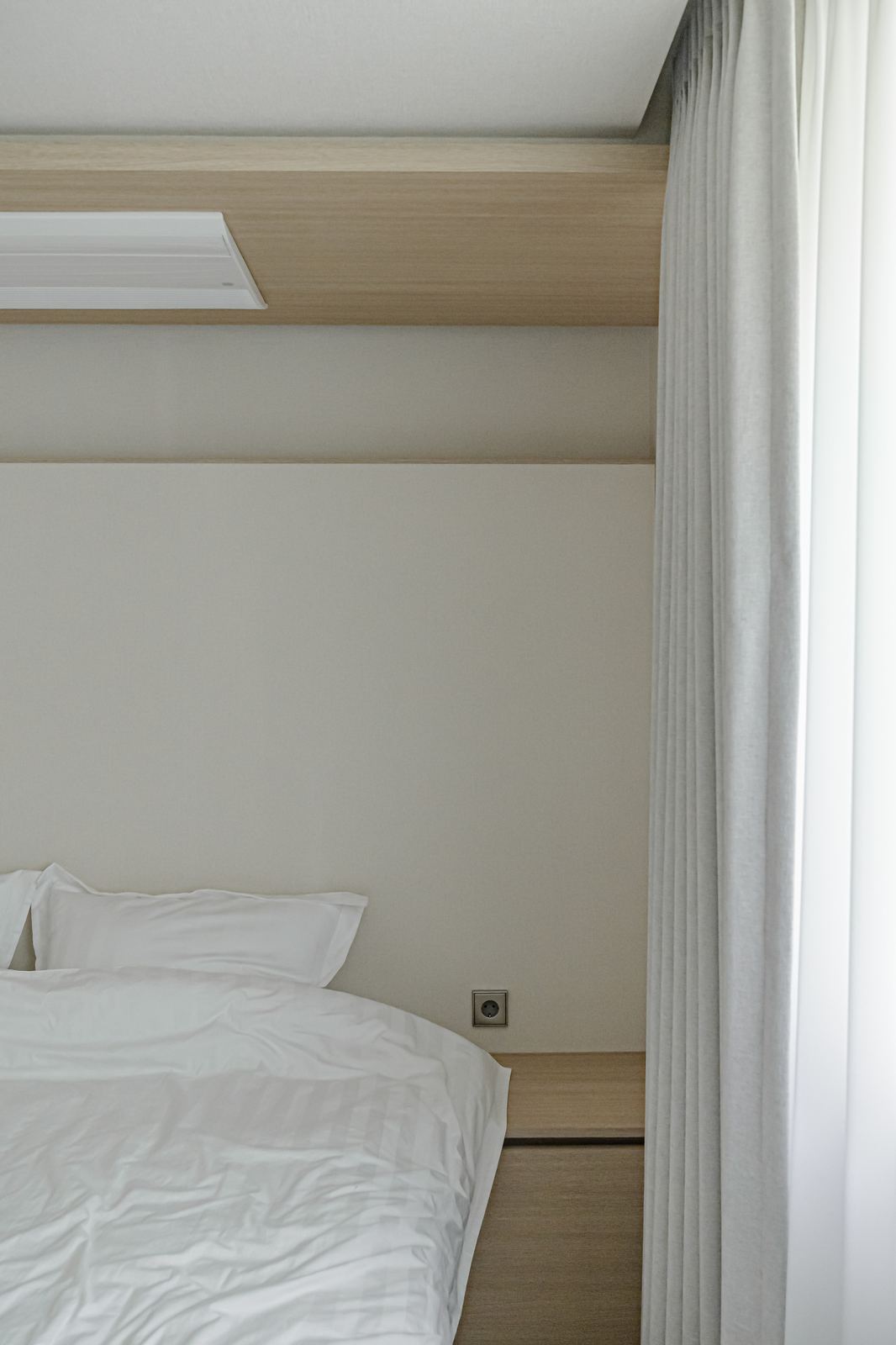 Style reference: a bedroom nook with a wood ceiling beam and sheer curtain