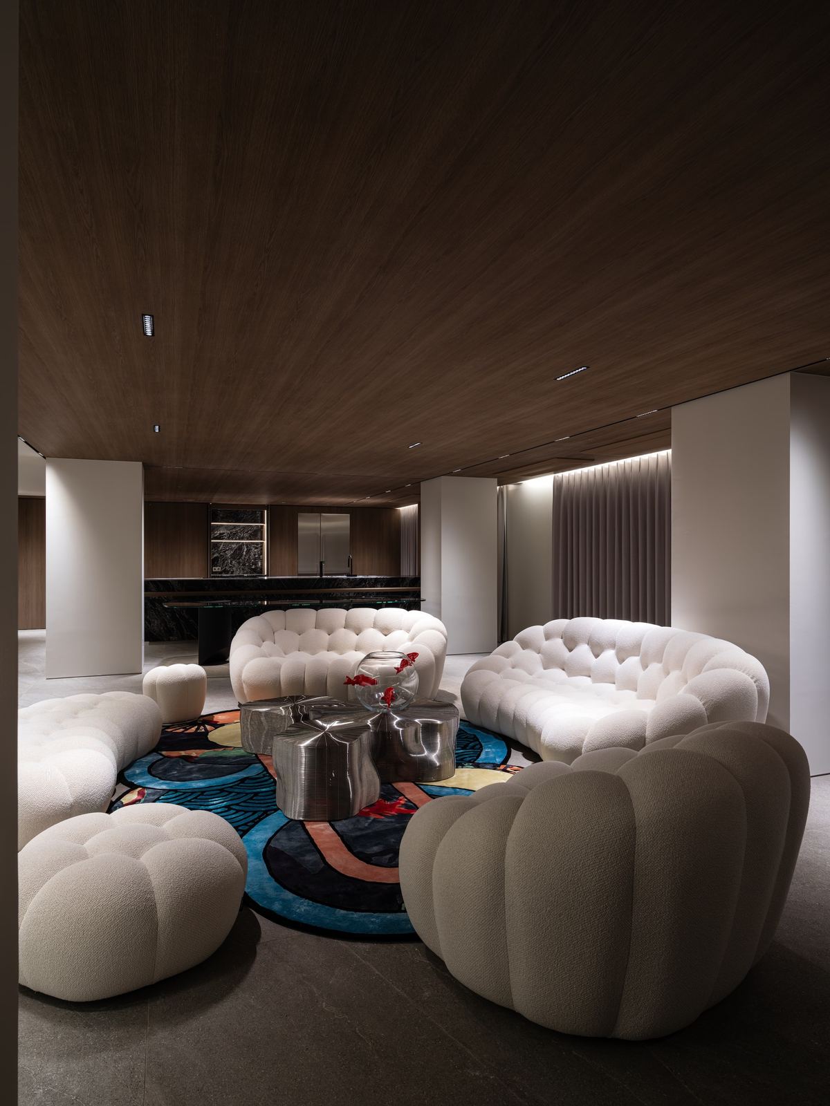 Style reference: a living room with bouclé bubble sofas and a patterned rug