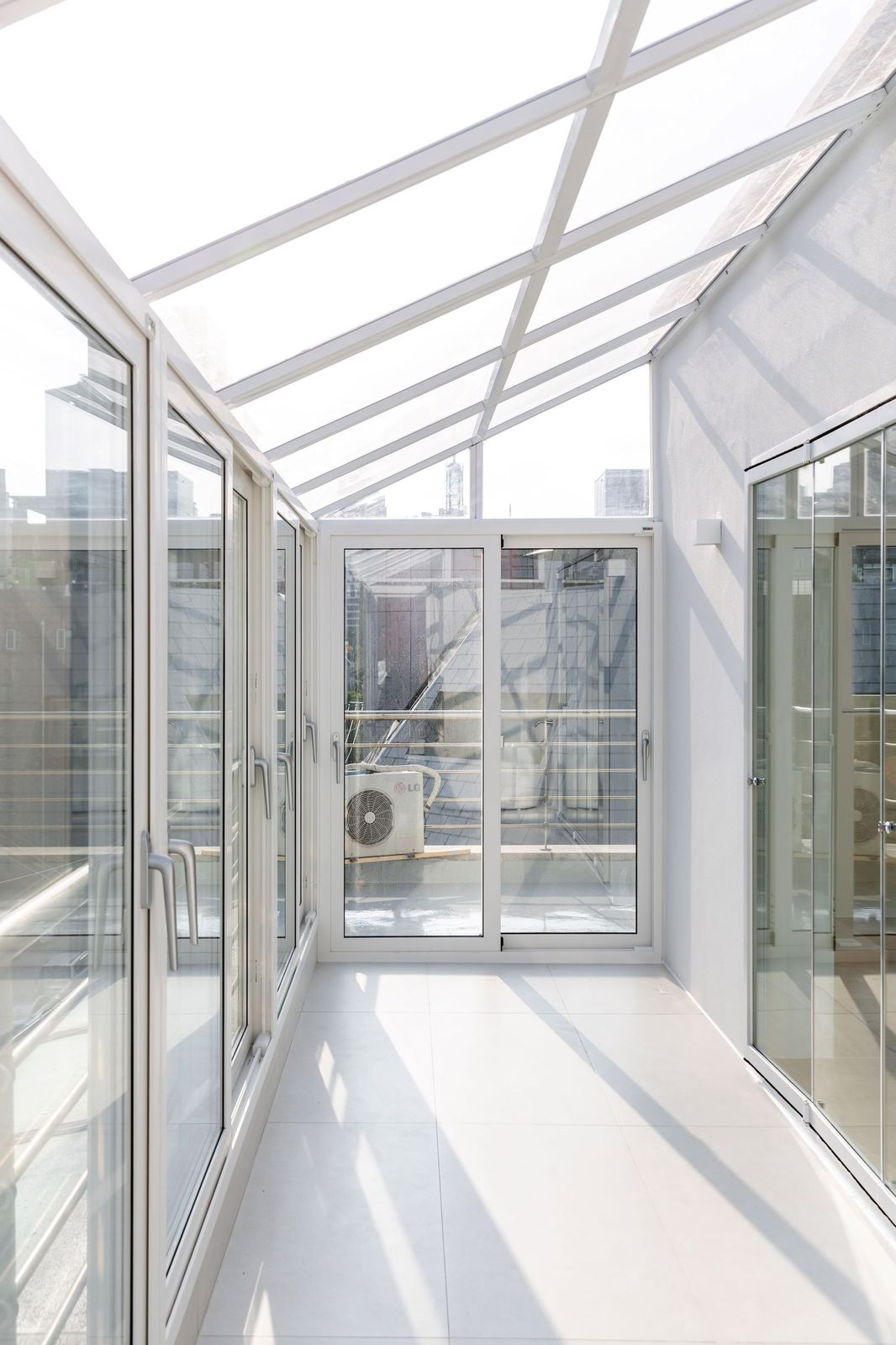 Style reference: a glazed balcony extension with a gabled glass roof